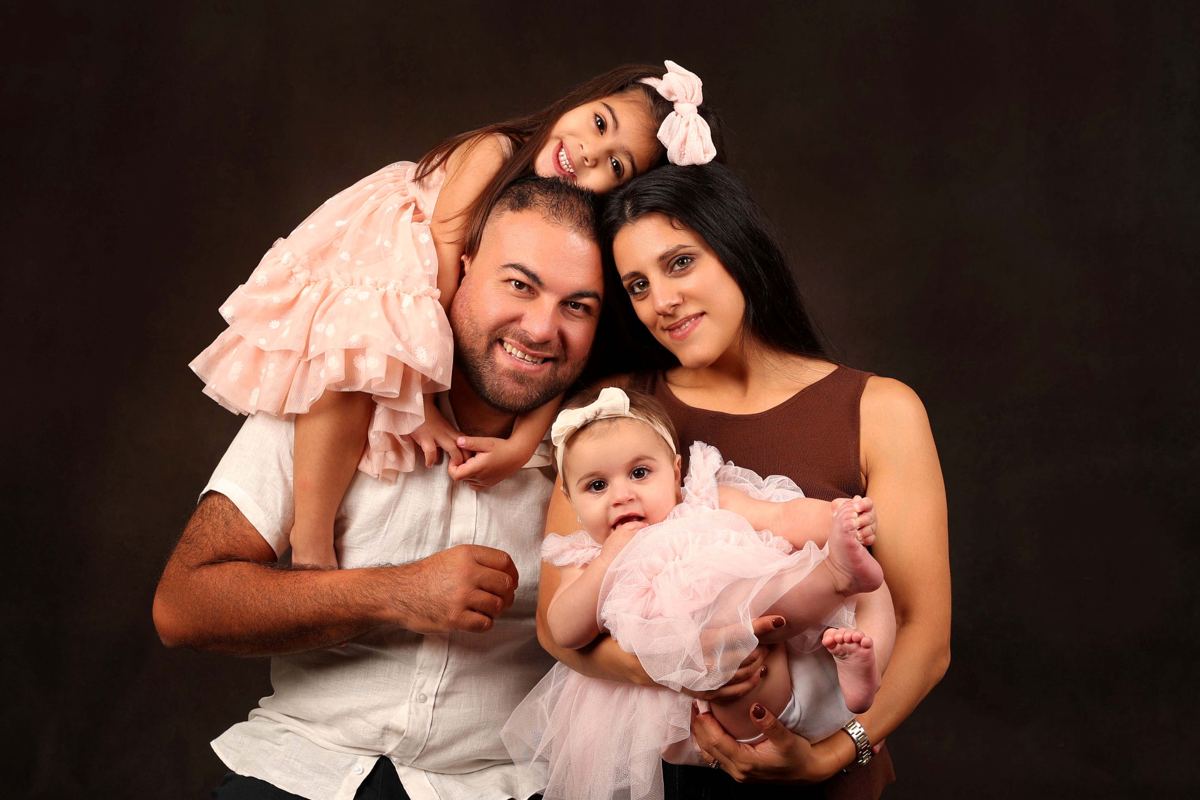 Parents with baby and daughter, studio portrait