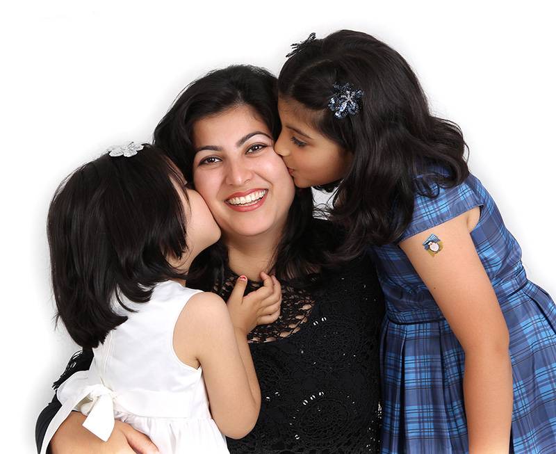 Sisters kissing mum